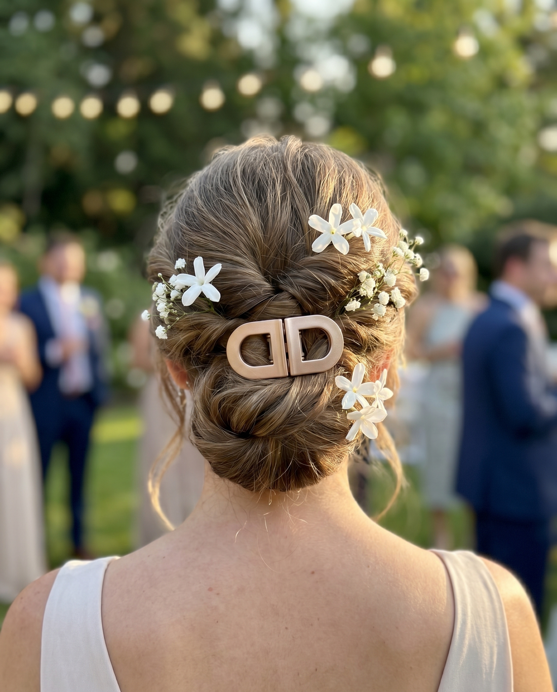 Chignon de mariée tenu par une pince beige Klipix, fleurs blanches, vue arrière